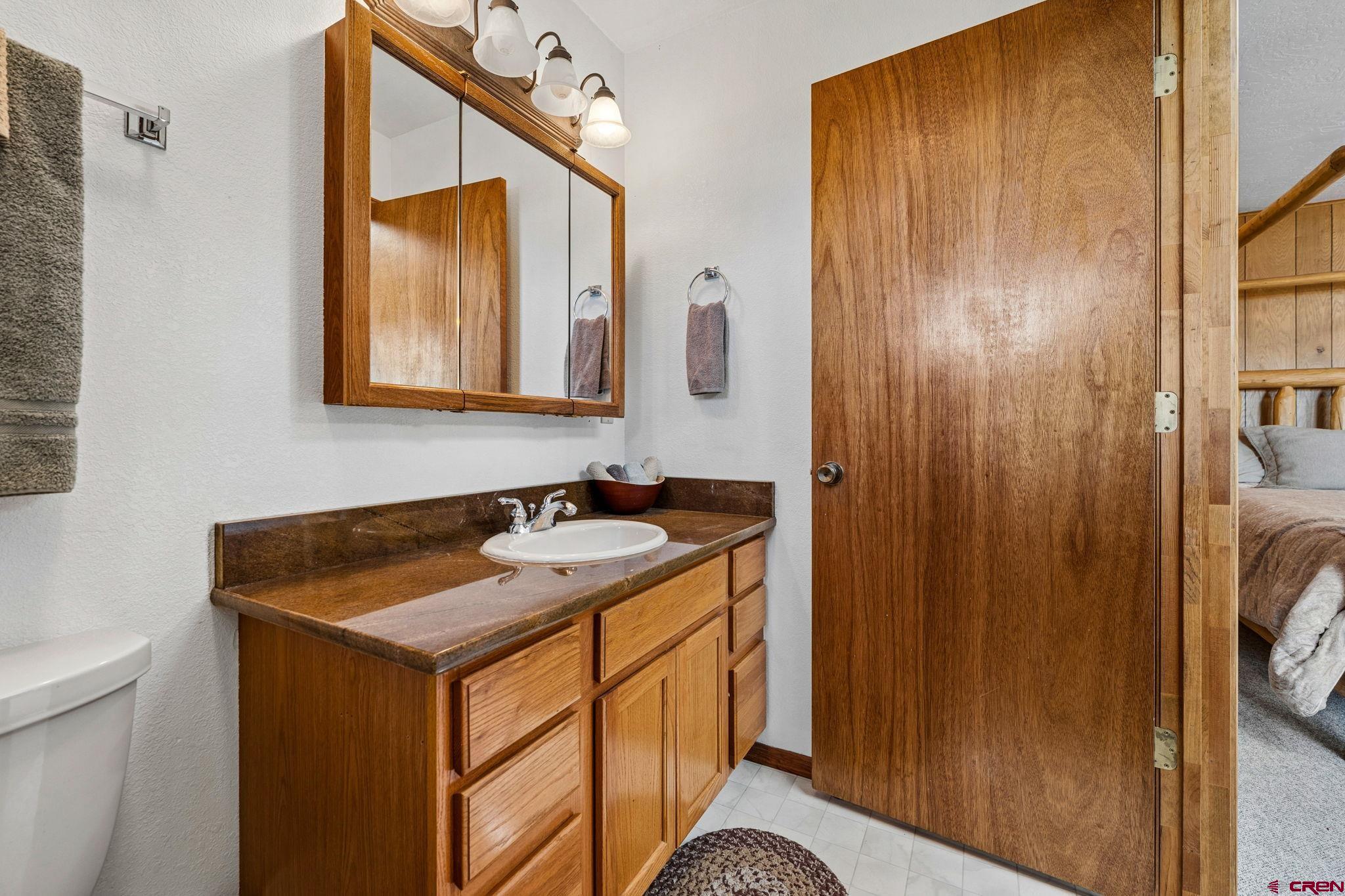 1024 Deer Ridge Drive Bayfield, CO 81122 - Photo 33 of 45 a bathroom with a sink and a mirror
