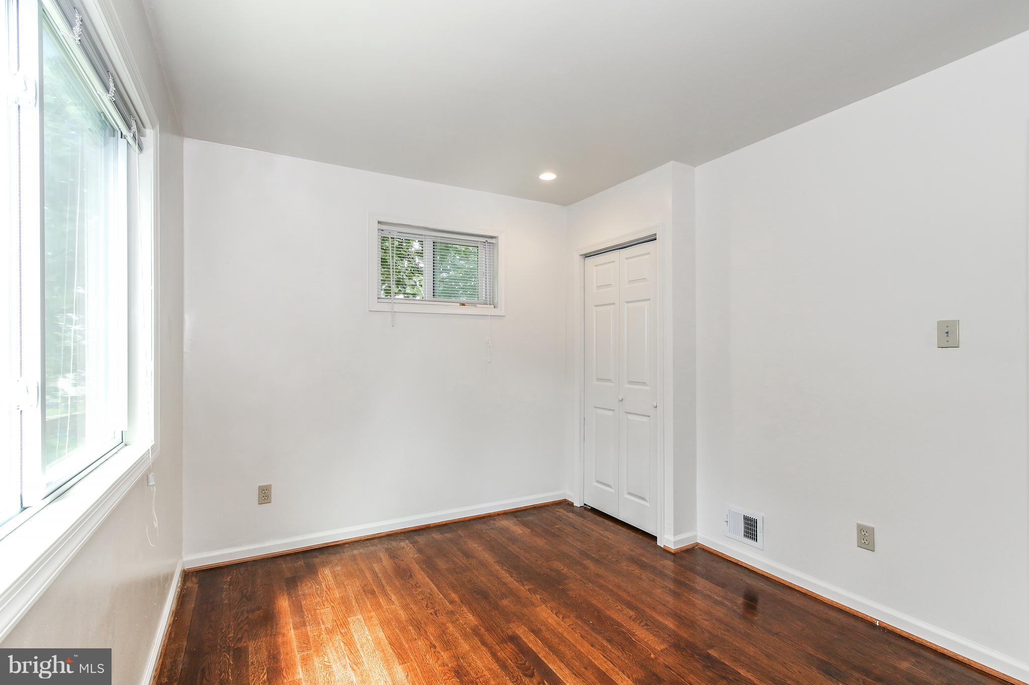 3306 Niles Street Silver Spring, MD 20906 - Photo 13 of 21 a view of an empty room with wooden floor and a window