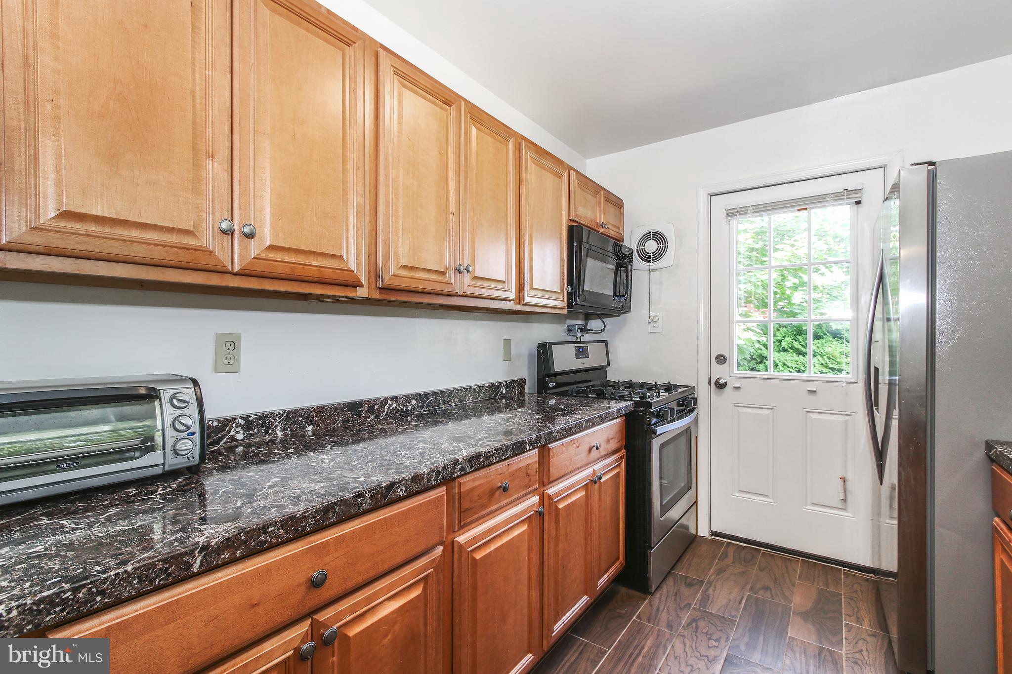 3306 Niles Street Silver Spring, MD 20906 - Photo 6 of 21 a kitchen with stainless steel appliances granite countertop a sink a stove and a refrigerator