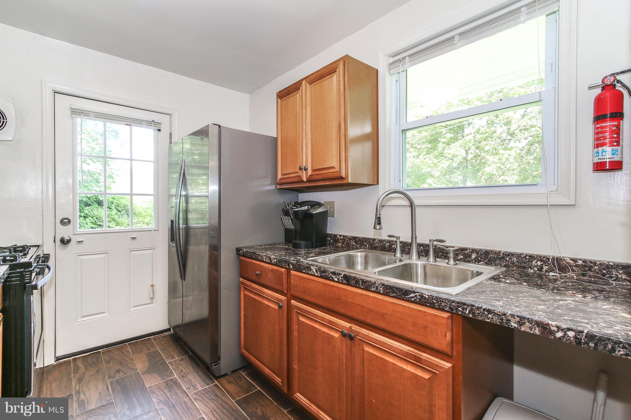 3306 Niles Street Silver Spring, MD 20906 - Photo 7 of 21 a kitchen with granite countertop a sink and a window