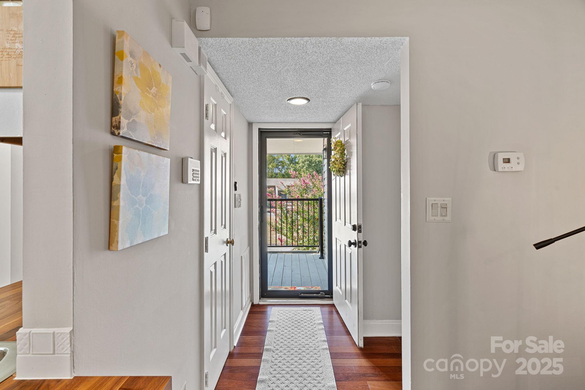 11017 Running Ridge Road Charlotte, NC 28226 - Photo 4 of 27 a view of a hallway with wooden floor and a bathroom