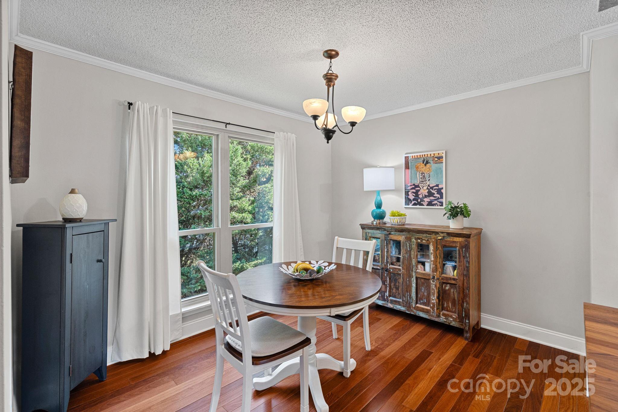 11017 Running Ridge Road Charlotte, NC 28226 - Photo 6 of 27 a view of a dining room with furniture window and wooden floor