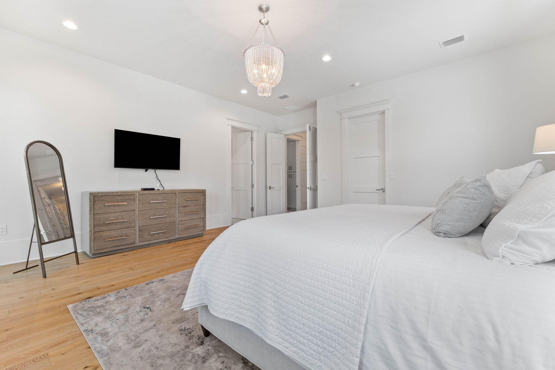 78 Banfill Road Santa Rosa Beach, FL 32459 - Photo 25 of 62 a spacious bedroom with a bed and a flat screen tv