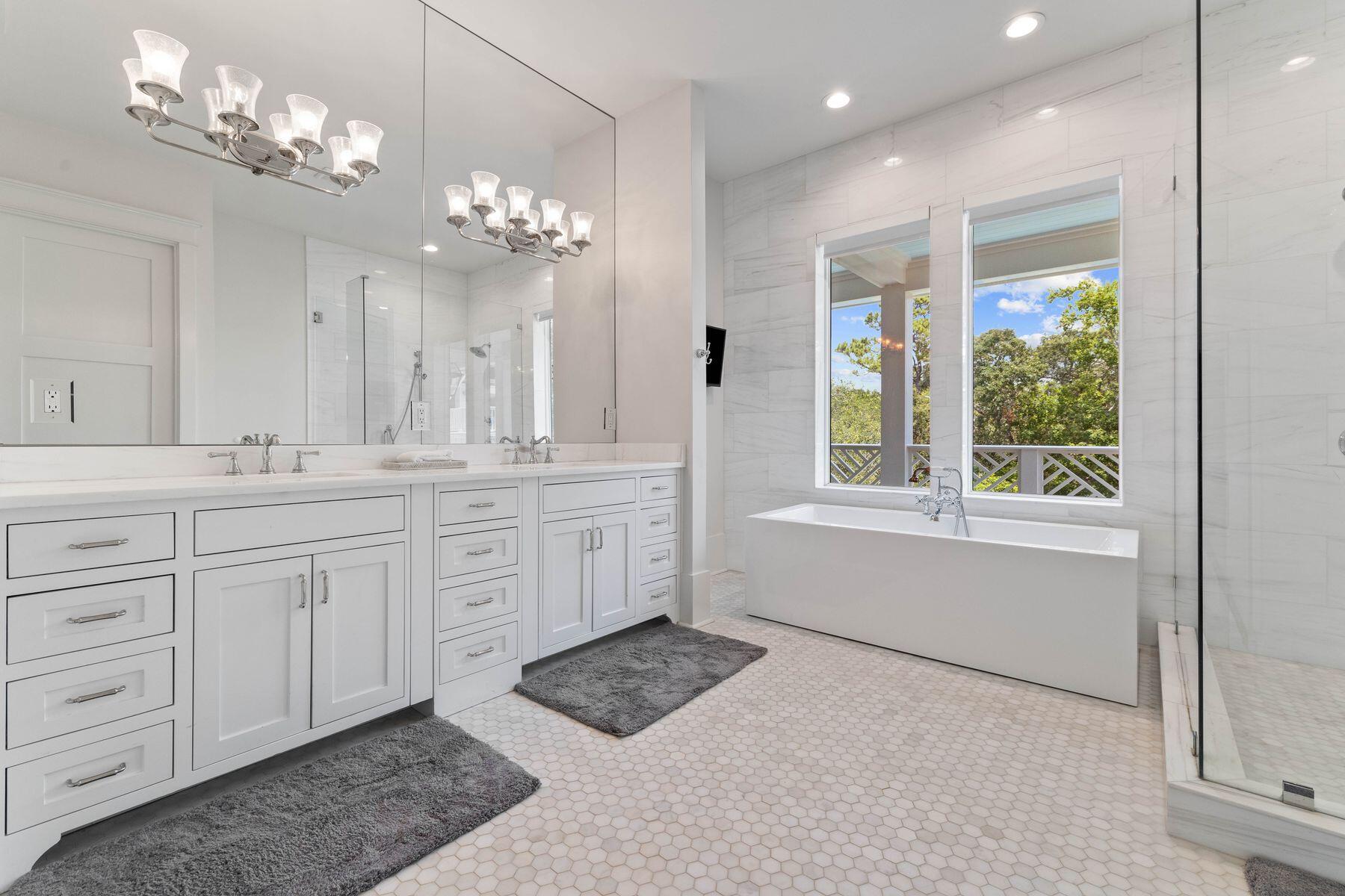 78 Banfill Road Santa Rosa Beach, FL 32459 - Photo 29 of 62 a spacious bathroom with a double vanity sink a large mirror and a bathtub