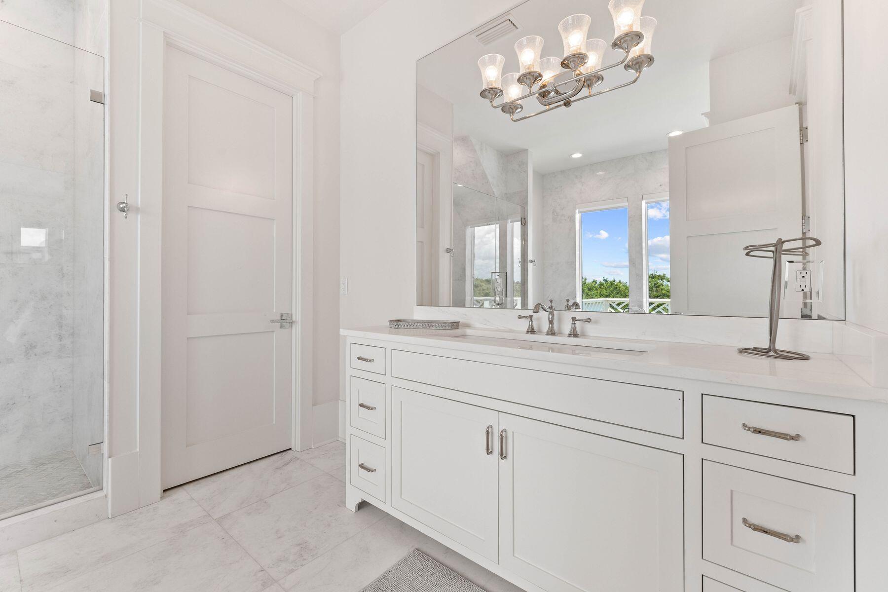 78 Banfill Road Santa Rosa Beach, FL 32459 - Photo 44 of 62 a bathroom with a sink vanity and a mirror