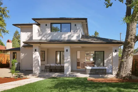 a view of a house with backyard porch and sitting area