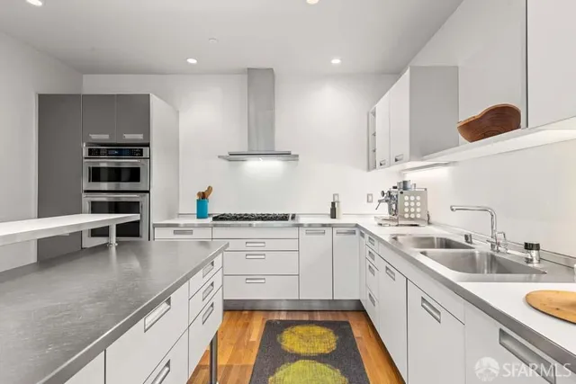 a kitchen with a sink appliances and cabinets