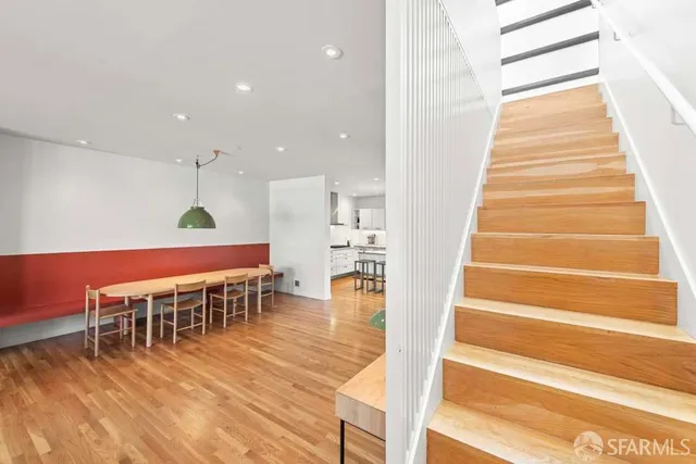 a dining room with furniture and wooden floor