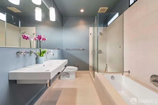 a white bath tub sitting next to a white sink