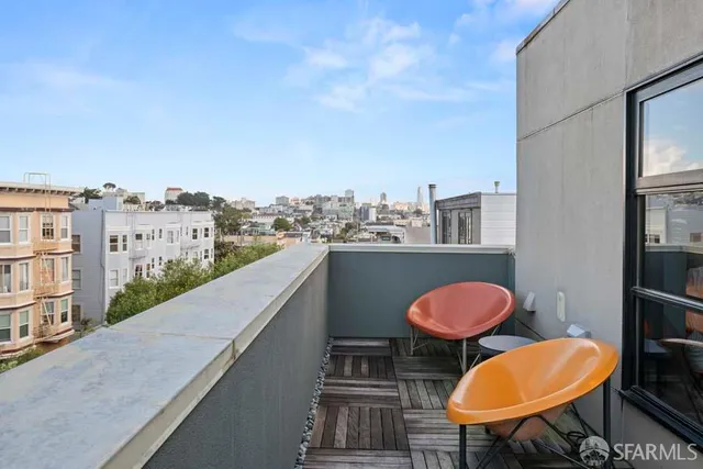 a view of a balcony with table and chairs