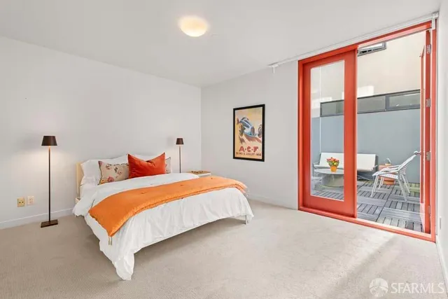 a bed sitting in a bedroom next to a window