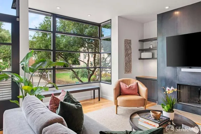 a living room with fireplace furniture and a flat screen tv