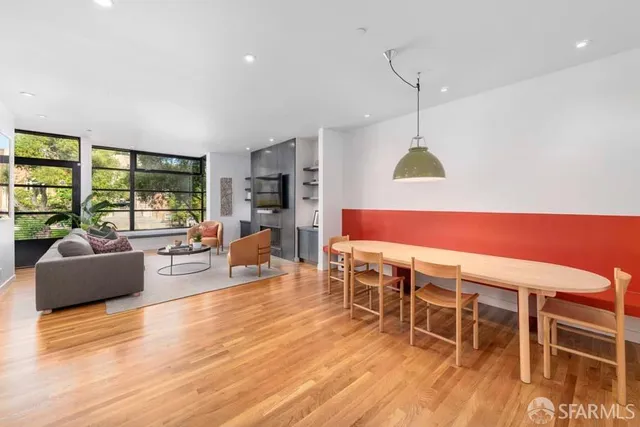 a living room with furniture a wooden floor and a window