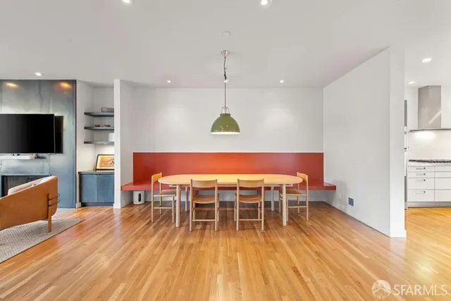 a dining room with a table chairs and a kitchen view