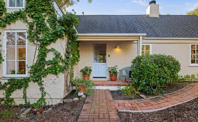 a front view of a house with garden