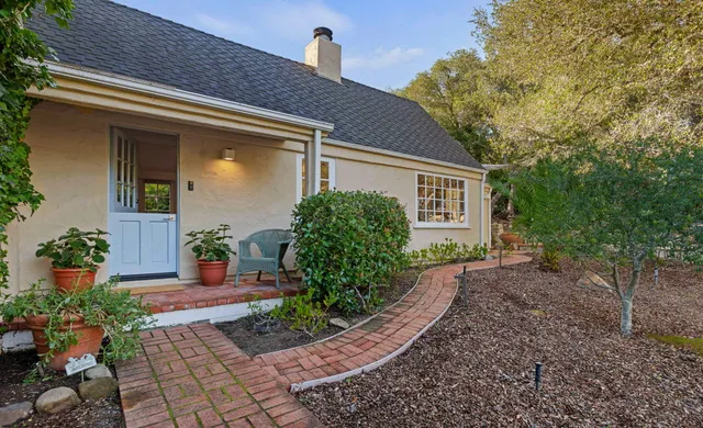 a front view of a house with garden