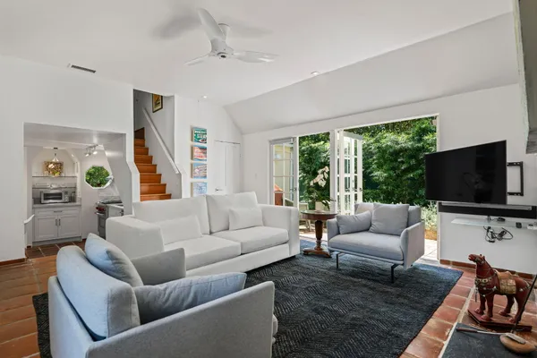 a living room with furniture a fireplace and a flat screen tv