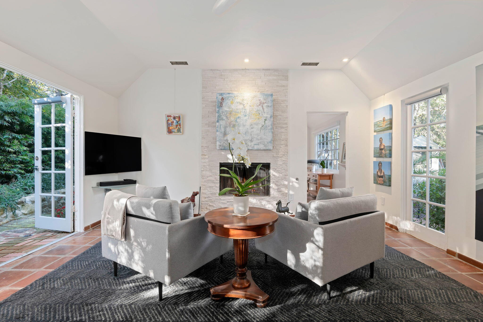 811 Picacho Lane Montecito, CA 93108 - Photo 9 of 22 a living room with furniture a flat screen tv and a large window