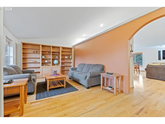 a living room with furniture a large window and a flat screen tv