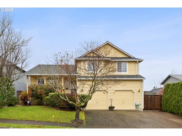 a view of a house next to a yard with big trees