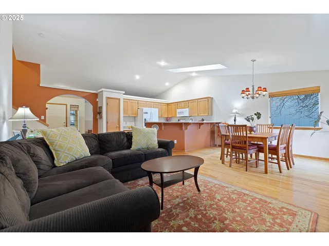 a living room with furniture and a dining table