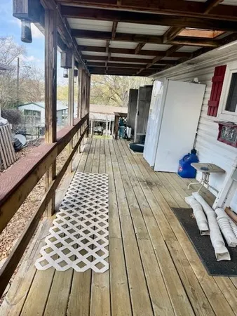 a view of balcony with wooden floor
