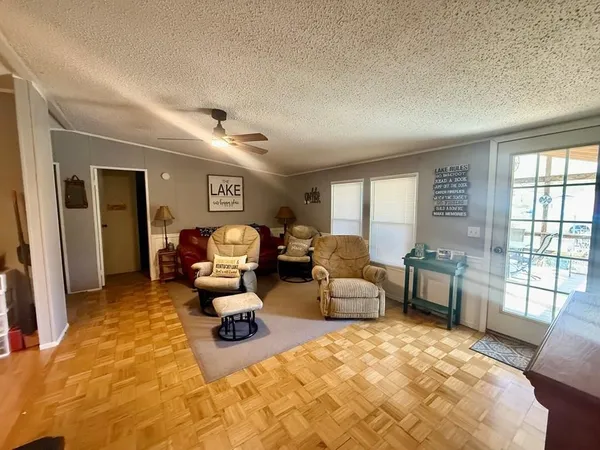 a bedroom with furniture and a large window