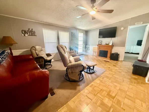 a living room with furniture a fireplace and a flat screen tv