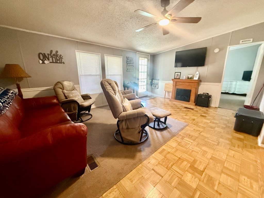 220 Sullivan Drive Springville, TN 38256 - Photo 4 of 17 a living room with furniture a fireplace and a flat screen tv