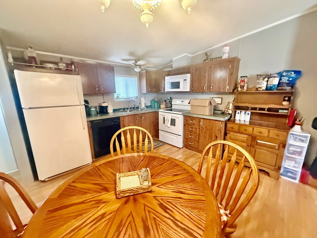 220 Sullivan Drive Springville, TN 38256 - Photo 6 of 17 a kitchen with stainless steel appliances granite countertop a refrigerator a stove a sink dishwasher with a dining table and chairs