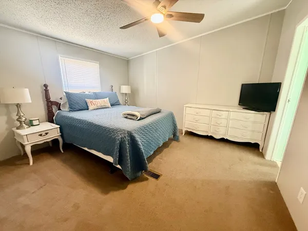 a bedroom with a bed and a couch
