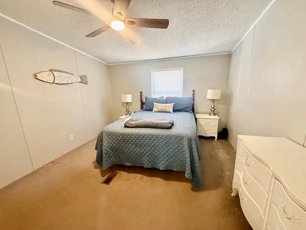 a bedroom with a bed and ceiling fan