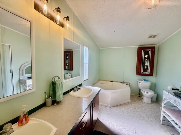 a en suite bathroom with a double vanity sink and a mirror