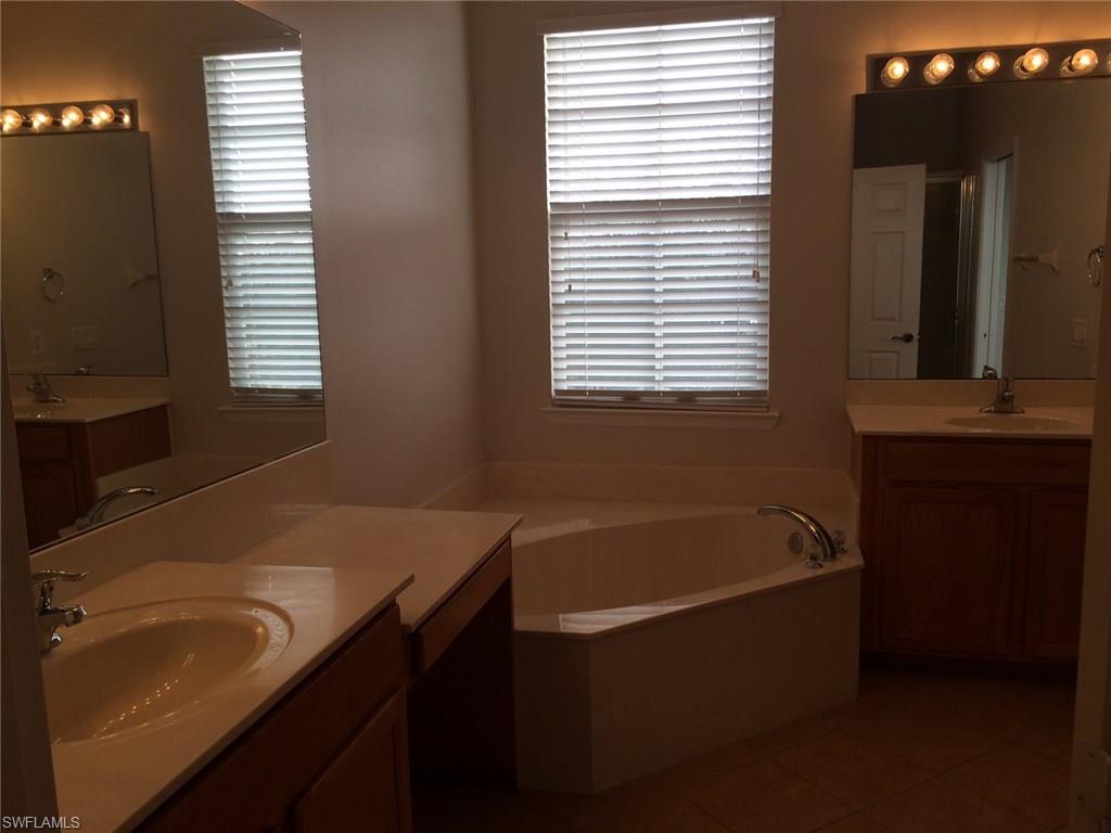 3954 Cherrybrook Loop Fort Myers, FL 33966 - Photo 10 of 16 a bathroom with a tub sink and mirror