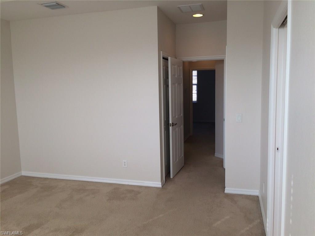 3954 Cherrybrook Loop Fort Myers, FL 33966 - Photo 16 of 16 a view of an empty room with closet and wooden door