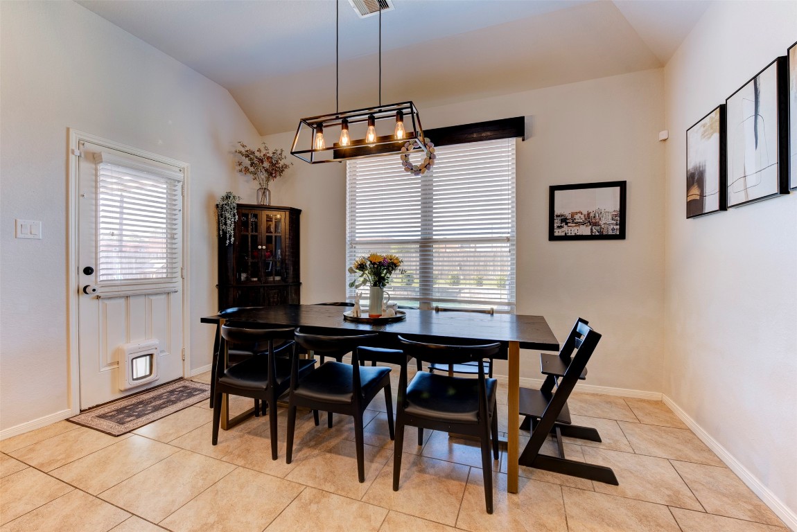 22939 Banff Brook Way Tomball, TX 77375 - Photo 11 of 25 Inviting dining space with modern lighting, large windows, and easy access to the backyard—perfect for entertaining.