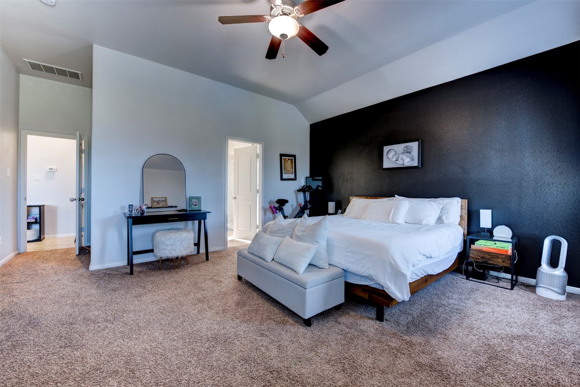 22939 Banff Brook Way Tomball, TX 77375 - Photo 14 of 25 Generous primary bedroom with high ceilings and versatile layout, creating a comfortable and private retreat.