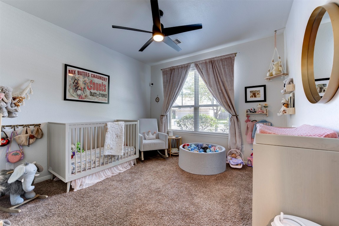 22939 Banff Brook Way Tomball, TX 77375 - Photo 16 of 25 Cozy secondary bedroom with soft natural light and ample space—ideal for a nursery or guest room.