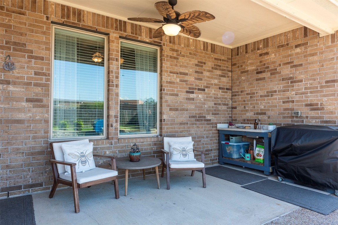 22939 Banff Brook Way Tomball, TX 77375 - Photo 22 of 25 Spacious covered patio with ceiling fan, ideal for outdoor lounging and entertaining year-round.