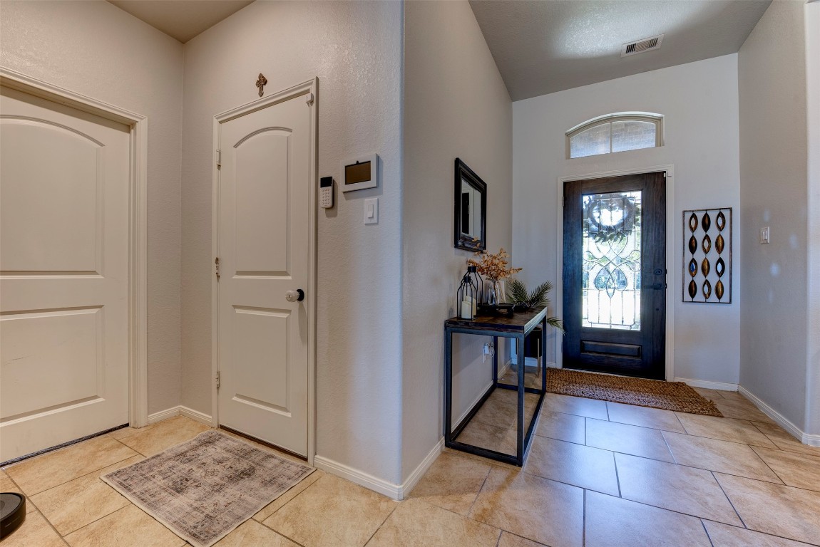 22939 Banff Brook Way Tomball, TX 77375 - Photo 3 of 25 Spacious foyer with tile flooring and ample wall space—perfect for showcasing décor while maintaining an open feel.