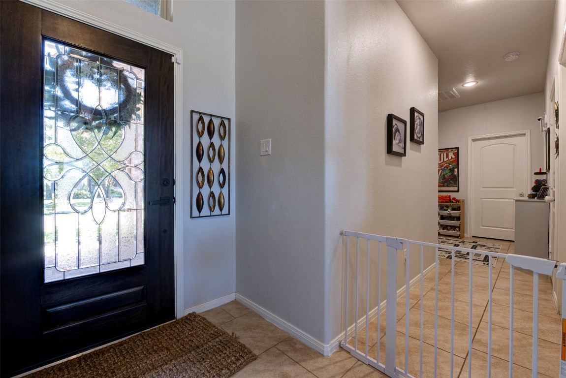 22939 Banff Brook Way Tomball, TX 77375 - Photo 4 of 25 Grand entry featuring a decorative glass front door, high ceilings, and clean lines that lead into the main living areas.