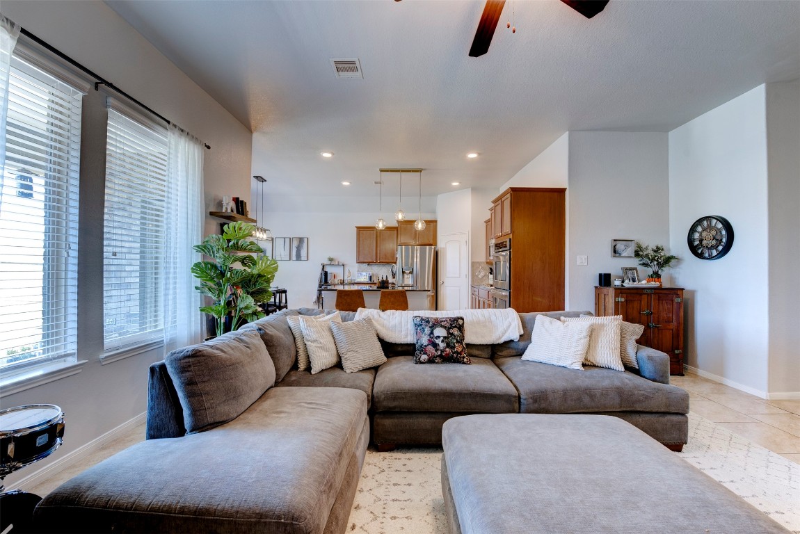 22939 Banff Brook Way Tomball, TX 77375 - Photo 8 of 25 Spacious open-concept living area featuring abundant natural light and seamless flow into the kitchen—perfect for everyday living and entertaining.
