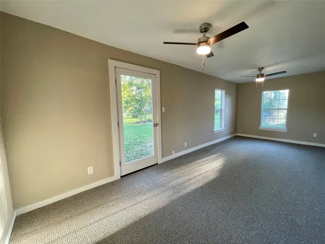 a view of a livingroom with a ceiling fan and window