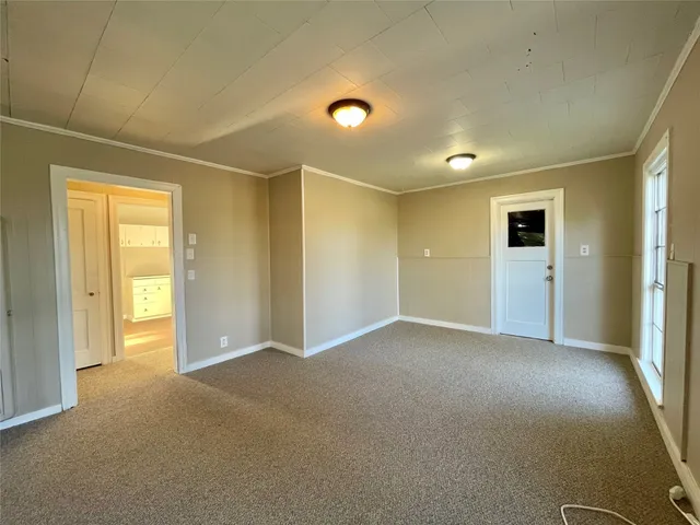 an empty room with closet and a bathroom