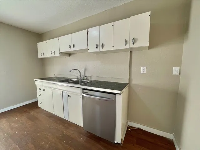 a view of cabinets a sink and dishwasher in a kitchen