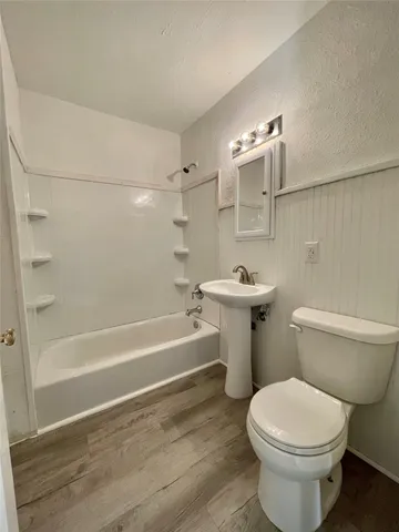 a bathroom with a sink a toilet and bathtub