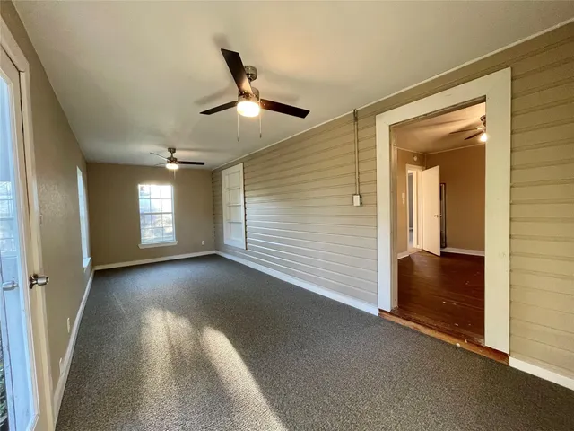 a view of an empty room and a window