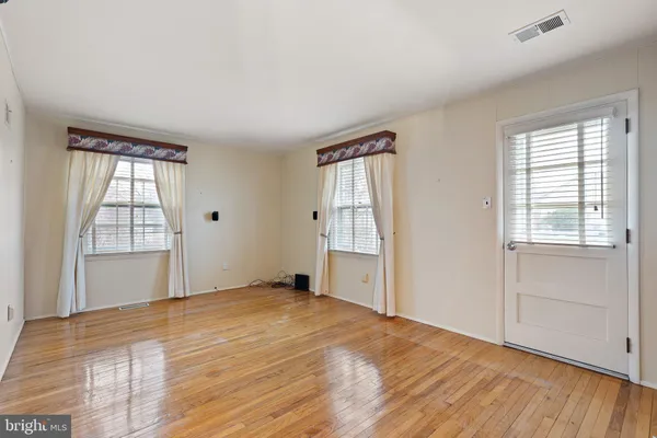 an empty room with windows and closet