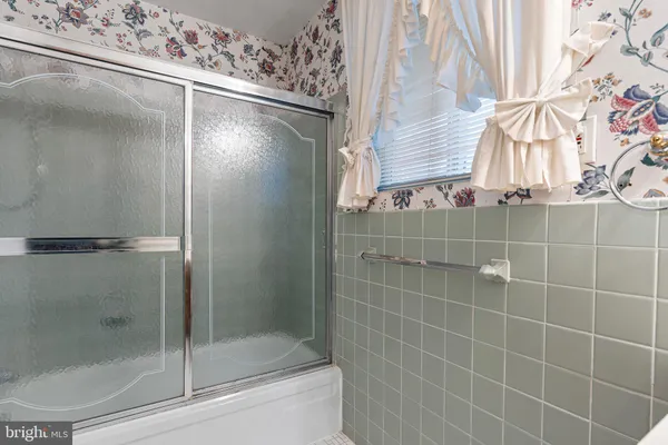 a bathroom with a glass shower door