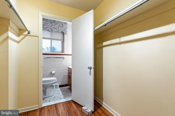 a bathroom with a toilet and a shower curtain